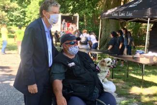 Governor McKee with a man and his dog